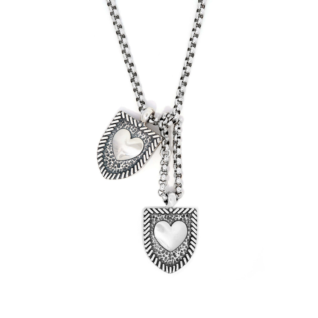 Courageous Love Tags necklace in sterling silver featuring two shield-shaped pendants with heart centers on a silver chain, symbolizing love and connection.