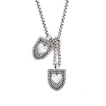 Courageous Love Tags necklace in sterling silver featuring two shield-shaped pendants with heart centers on a silver chain, symbolizing love and connection.