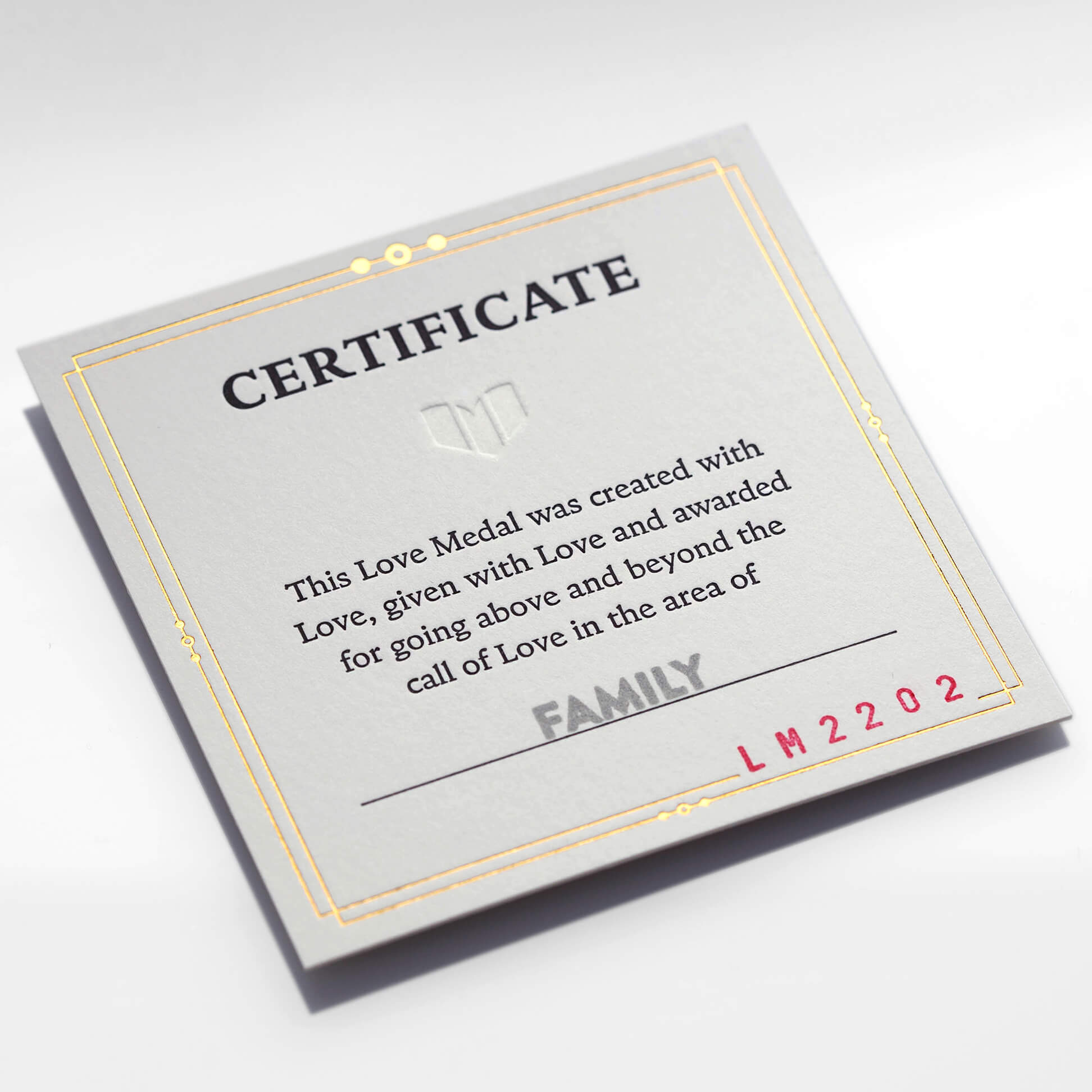 Customizable Love Medal certificate with gold border, personalized with the word 'family' to signify what the Love Medal is being awarded for and a unique series production number.